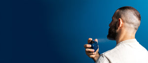 A set of Mark Des Vince perfumes placed on white rocks with leaves behind, for photography.